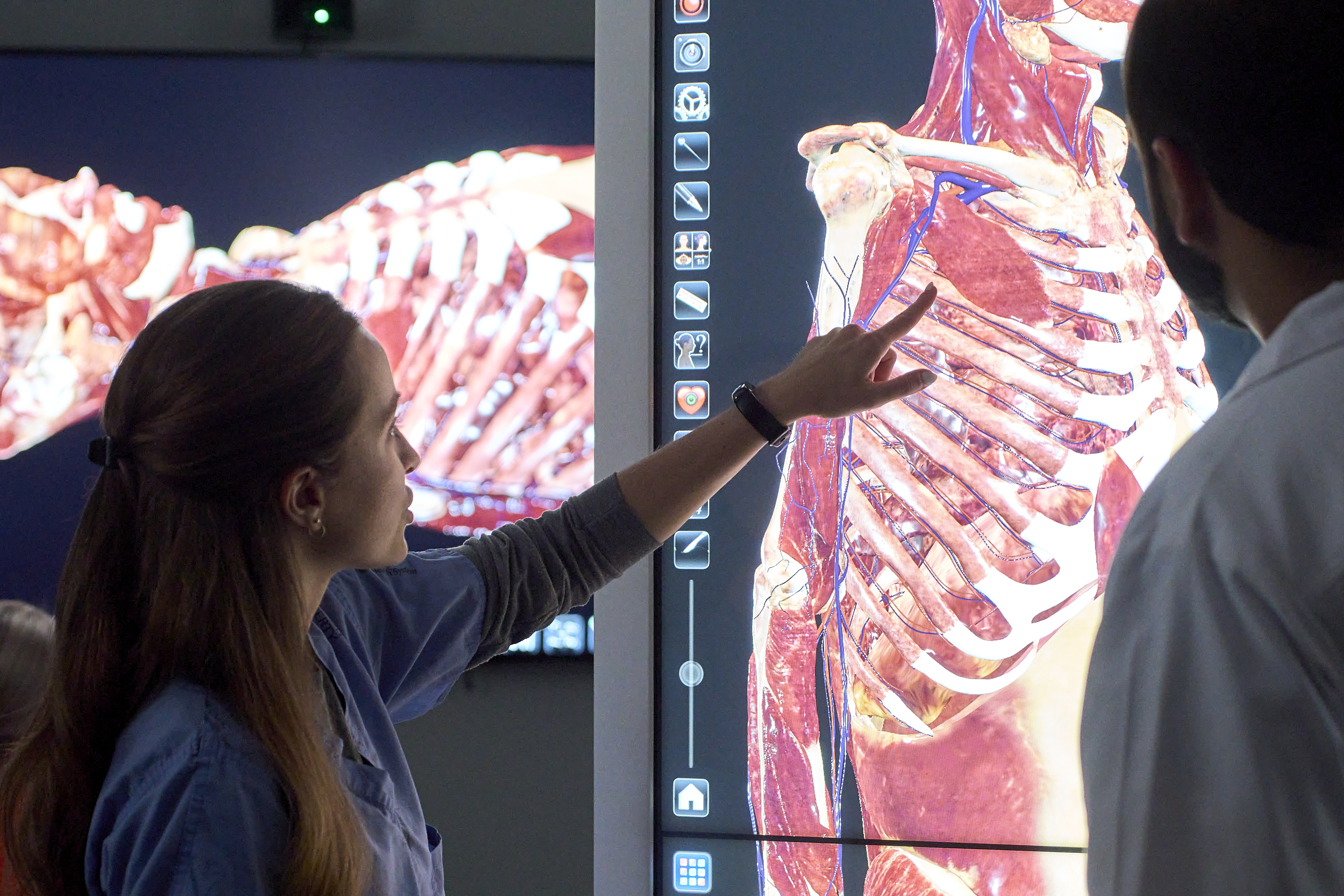 Resident and instructor viewing anatomage table