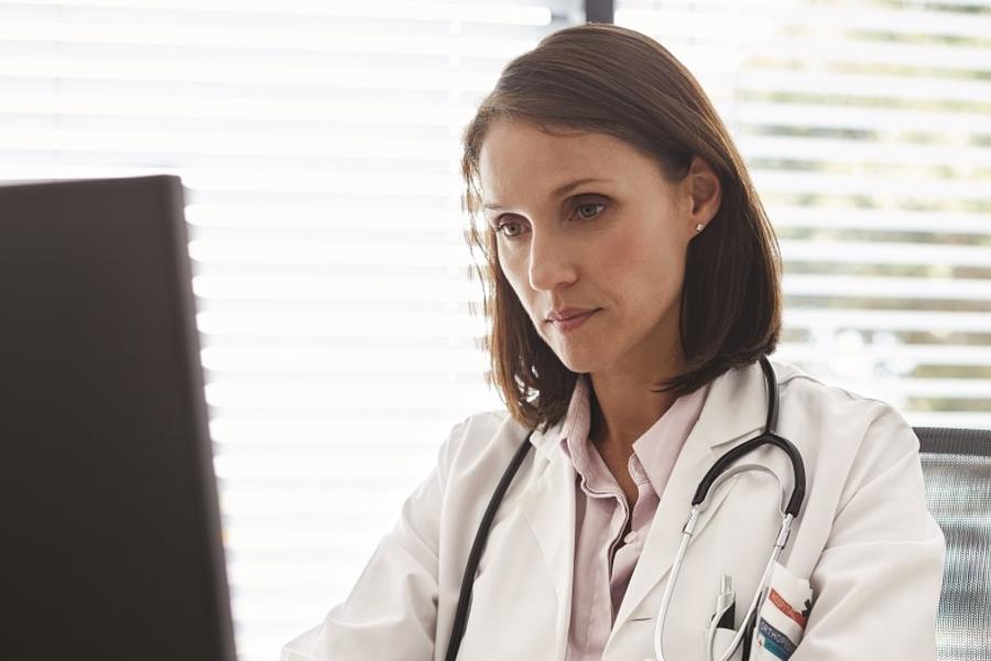 Physician working on computer.